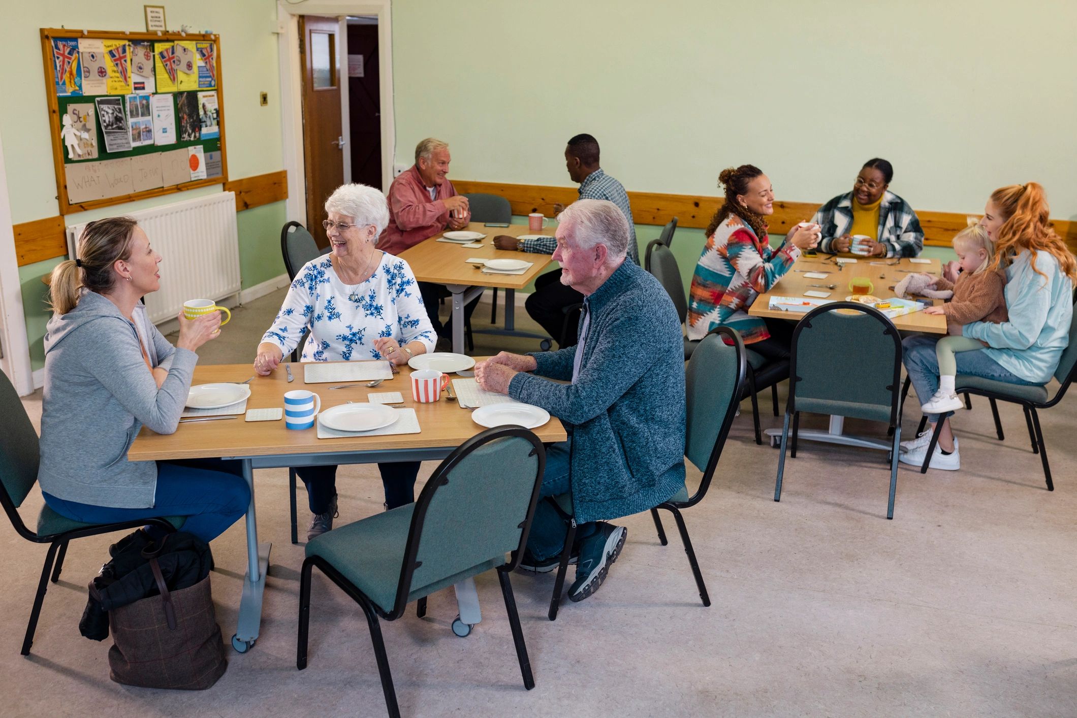 Community members gathering in a warm and welcoming support space