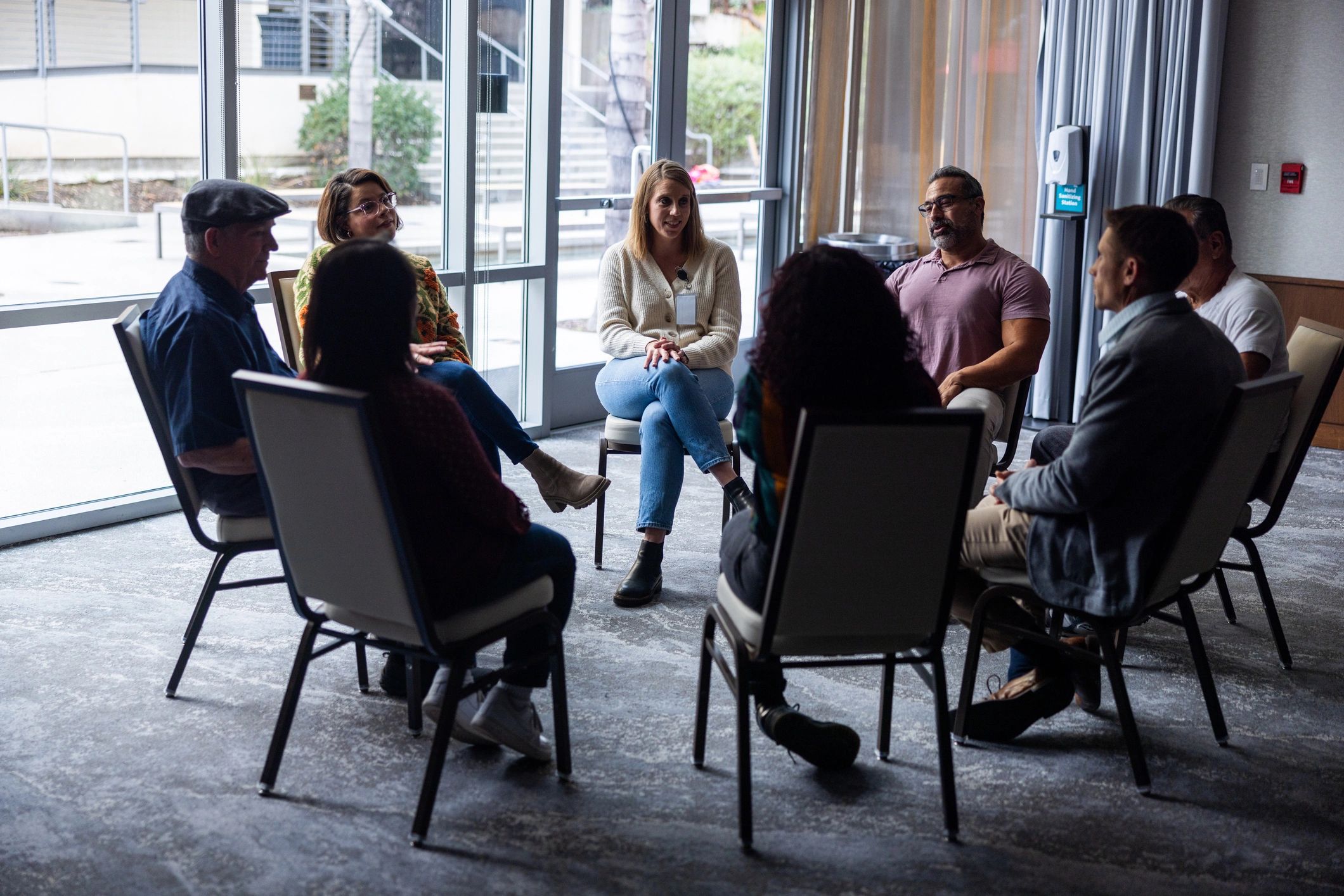People gathered in a welcoming community support discussion